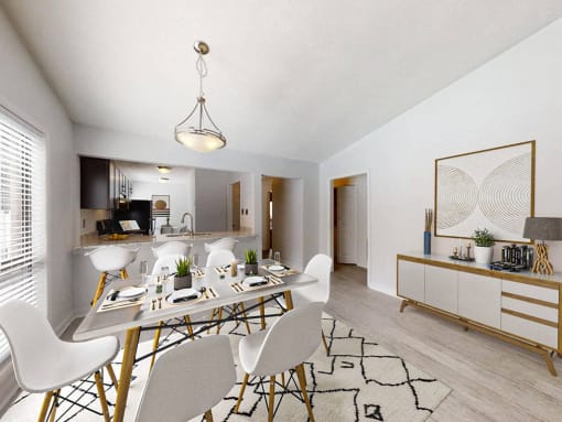 a dining room and kitchen area with a table and chairs