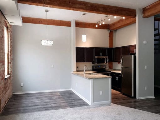 an empty kitchen with an island in the middle of it
