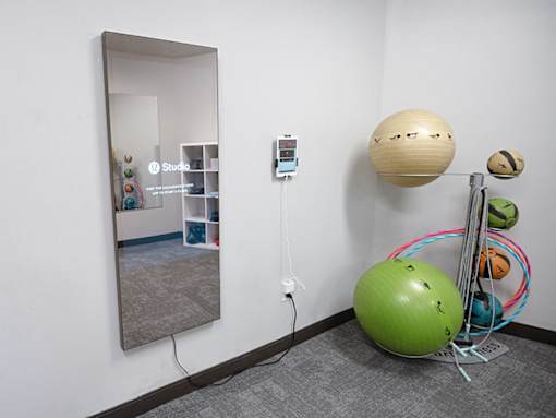 a room with a mirror and a ball on the wall