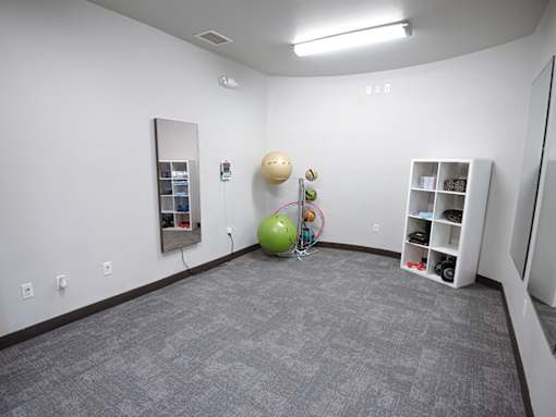 room with a green ball and a mirror in the corner