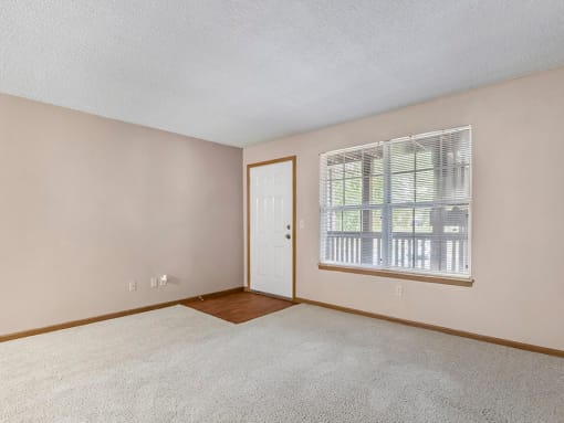a bedroom with a large window and a door