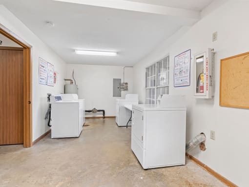 a laundry room with washers and dryers in it