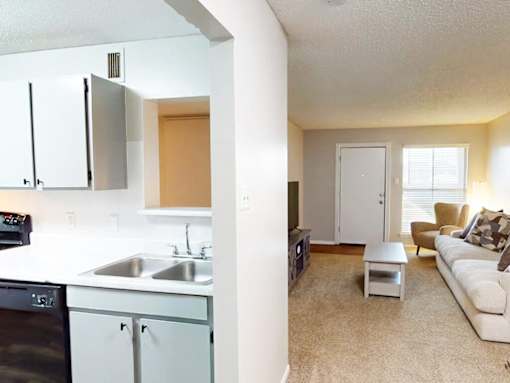 A kitchen with a sink and a refrigerator.