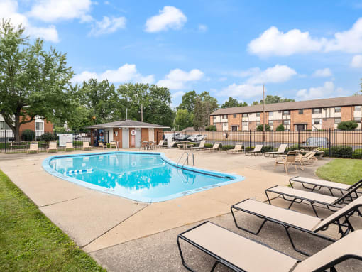 apartments with a swimming pool with loungechairs
