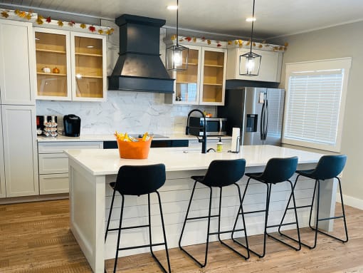 apartment kitchen with a center island and bar stools