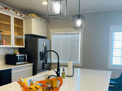 a kitchen with white cabinets and a counter top