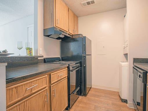 a kitchen with a refrigerator and a stove and a sink