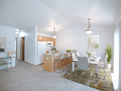 a living room and kitchen with a dining table and chairs