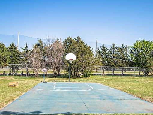 A basketball court with a net and a basketball hoop.