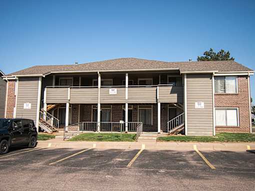 A building with a parking lot in front of it.