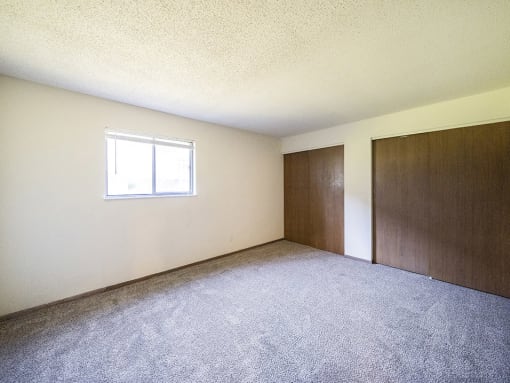spacious primary bedroom with closets