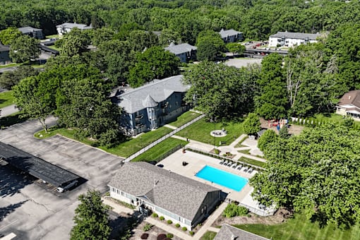 A bird's eye view of a residential area with a swimming pool.