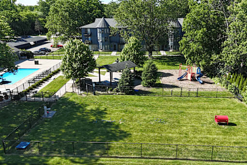 A backyard with a pool and a slide.