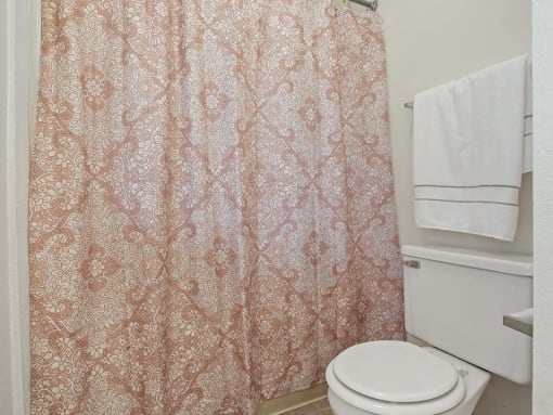 apartment bathroom with a toilet and a shower curtain