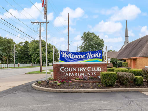 welcome sign at Country Club Apartments