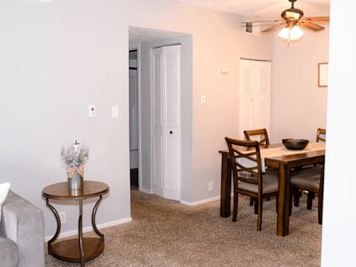 A dining room with a table and chairs.