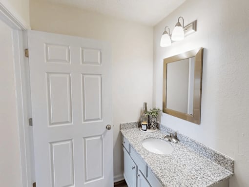 an empty bathroom with a sink and a mirror