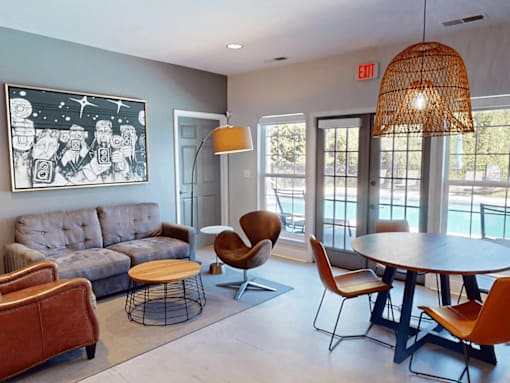 a living room with a couch and a table and chairs