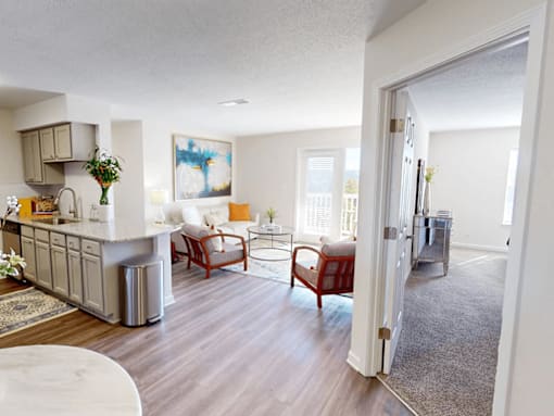 a living room with a kitchen and a dining room
