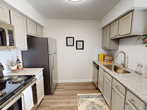 a kitchen with granite counter tops and stainless steel appliances