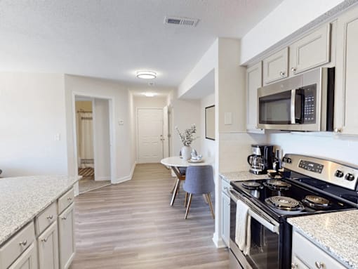 apartment kitchen with appliances including a microwave