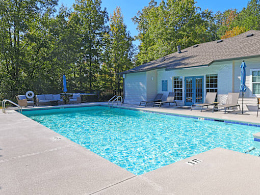 a swimming pool with a house in the background