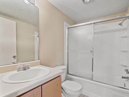 One bedroom bathroom with a sink toilet and shower