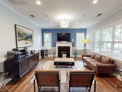 A living room with a fireplace and a television.