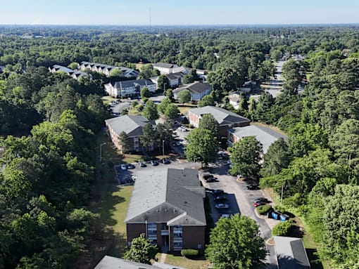 A bird's eye view of a residential area with houses and trees.
