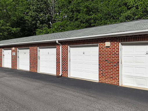 A row of white garage doors are closed.