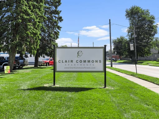 a welcome sign for Clair Commons Apartments