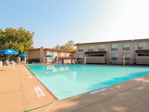 A swimming pool in front of apartment buildings.