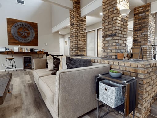 A living room with a couch and a fireplace.