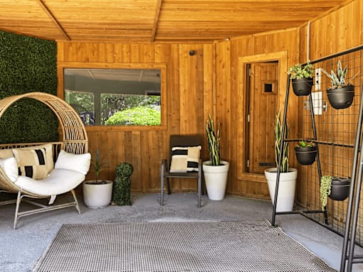A room with wooden walls and a hanging chair.