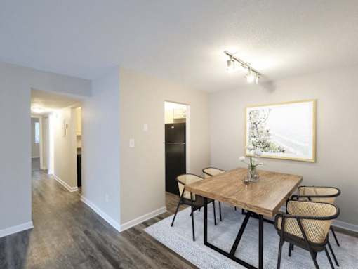 A dining room with a wooden table and chairs.