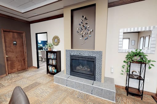 A living room with a fireplace and a chair.