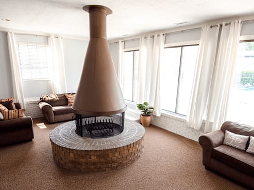 A living room with a large fireplace and a couch.