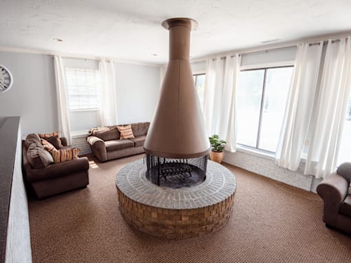 A living room with a fireplace and a couch.