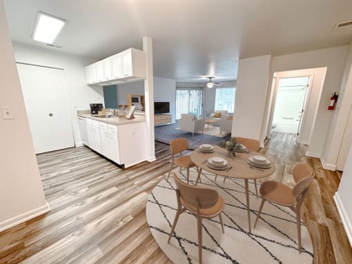 an open floor plan with a dining table and chairs
