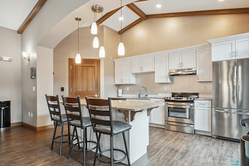 A kitchen with a white counter and stainless steel appliances.