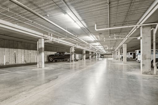 A black and white image of a large, empty parking garage.