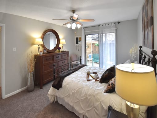 Bedroom with ceiling fan and large window