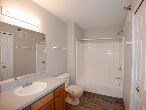 a bathroom with a toilet sink and shower