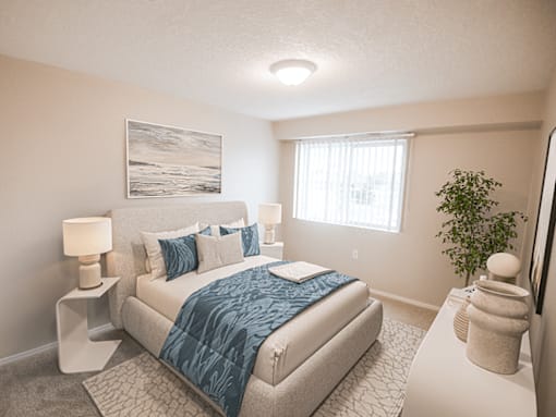 A bedroom with a bed, nightstands, and a plant.