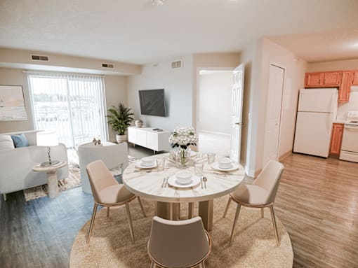 A dining room with a round table and chairs.
