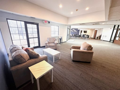 a large room in clubhouse with couches and chairs and a table