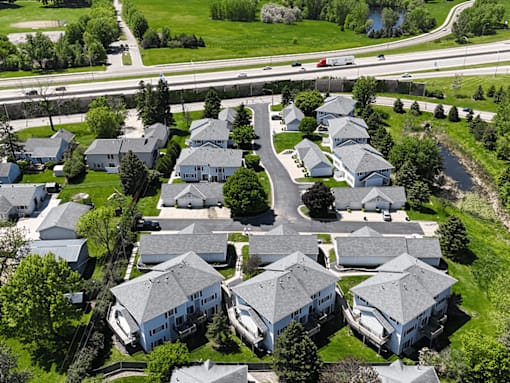 A suburban neighborhood with houses and a road.