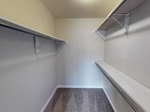 A storage room with shelves and a carpeted floor.