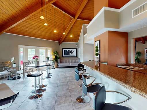 A modern living room with a bar area and a television.