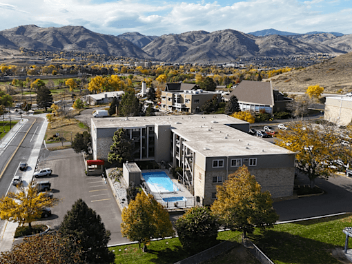 A large building with a pool in the middle of a parking lot.